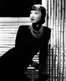 Anna May Wong (January 3, 1905 – February 3, 1961) was an American actress, the first Chinese American movie star, and the first Asian American to become an international star. Her long and varied career spanned both silent and sound film, television, stage, and radio.<br/><br/>

Born near the Chinatown neighborhood of Los Angeles to second-generation Chinese-American parents, Wong became infatuated with the movies and began acting in films at an early age. During the silent film era, she acted in The Toll of the Sea (1922), one of the first movies made in color and Douglas Fairbanks' The Thief of Bagdad (1924). Wong became a fashion icon, and by 1924 had achieved international stardom. Frustrated by the stereotypical supporting roles she reluctantly played in Hollywood, she left for Europe in the late 1920s, where she starred in several notable plays and films, among them Piccadilly (1929). She spent the first half of the 1930s traveling between the United States and Europe for film and stage work.<br/><br/> 

Wong was featured in films of the early sound era, such as Daughter of the Dragon (1931) and Daughter of Shanghai (1937), and with Marlene Dietrich in Josef von Sternberg's Shanghai Express (1932). In 1935 Wong was dealt the most severe disappointment of her career, when Metro-Goldwyn-Mayer refused to consider her for the leading role in its film version of Pearl S. Buck's The Good Earth, choosing instead the German actress Luise Rainer to play the leading role. Wong spent the next year touring China, visiting her family's ancestral village and studying Chinese culture.<br/><br/>

In the late 1930s, she starred in several B movies for Paramount Pictures, portraying Chinese-Americans in a positive light. She paid less attention to her film career during World War II, when she devoted her time and money to helping the Chinese cause against Japan. Wong returned to the public eye in the 1950s in several television appearances as well as her own series in 1951, The Gallery of Madame Liu-Tsong, the first U.S. television show starring an Asian-American. She had been planning to return to film in Flower Drum Song when she died in 1961, at the age of 56.