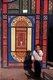 China: Young boy in front of his home's brightly decorated doors in Old Kuqa, Xinjiang Province