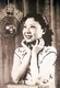 At a young age Bai joined the Bright Moonlight Song and Dance Troupe, where she entered the Shanghai entertainment industry. She used the stage name (白虹), which translates as 'White Rainbow'.<br/><br/>

By the 1930s, she was a popular icon, known for her mastery of language and clarity in expressing lyrics, which helped her gain many fans. In the 1930s, she was recognized as one of the three great 'mandopop' singers with Zhou Xuan and Gong Qiuxia.<br/><br/>

Her career peaked in the 1940s, when her music style changed more to uptempo jazz. She was married to the composer Li Jin Guang(黎锦光), though they later separated in a divorce in the 1950s. She stayed in China after 1949 and continued making films. During the Cultural Revolution her past association with the old Shanghai days caught up to her, and she was subjected to persecution and abuse. In 1992, she died at the age of 73.
